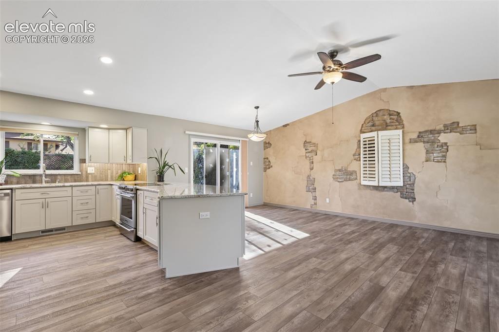 Image 6 of 32: Kitchen and DR with slider walk-out entry to back yard