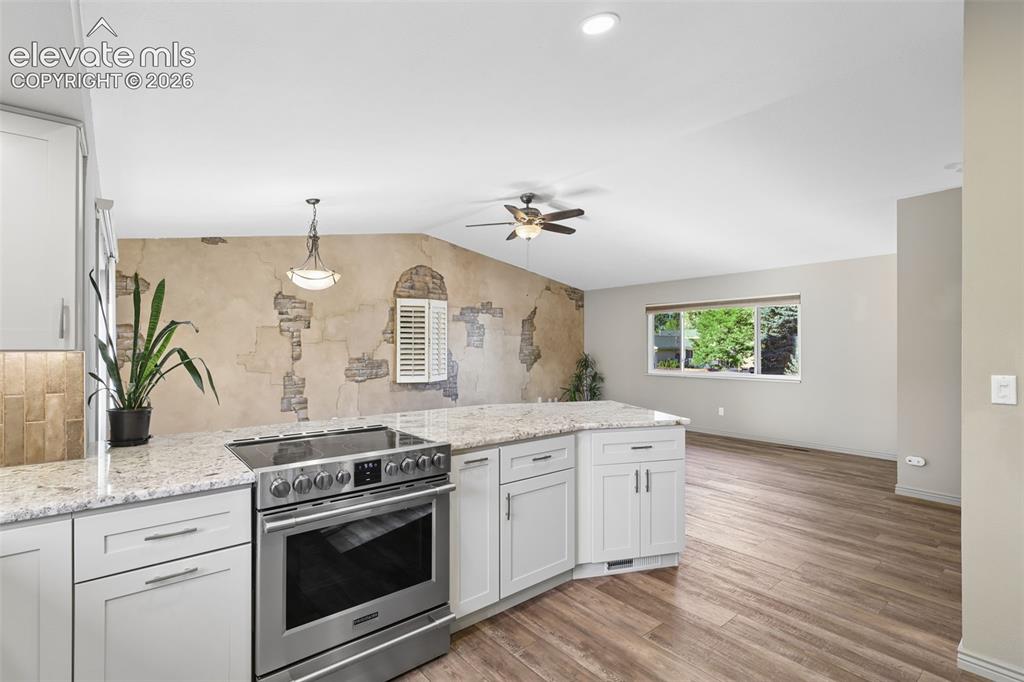 Image 7 of 32: Remodeled Kitchen with granite slab counters
