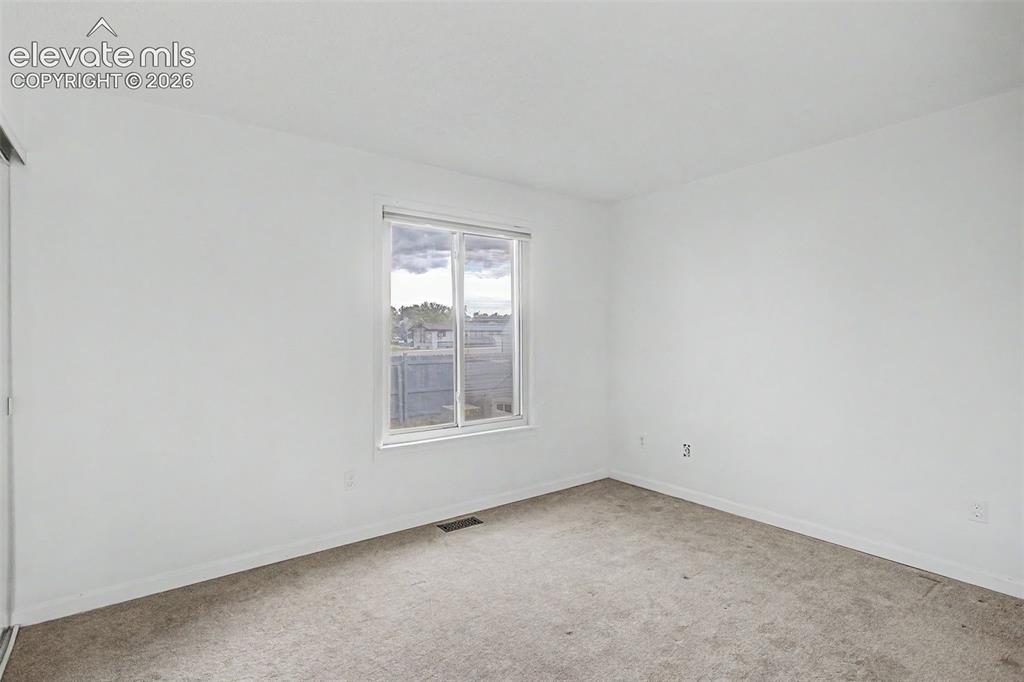 Image 16 of 37: Bright interior space featuring a double-paned window, neutral wall paint,