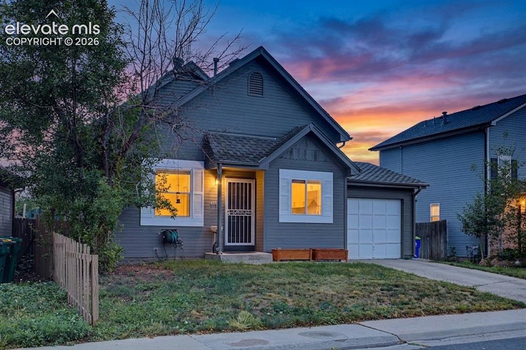 Image 2 of 37: Charming exterior featuring a peaked roofline, attached garage, white windo