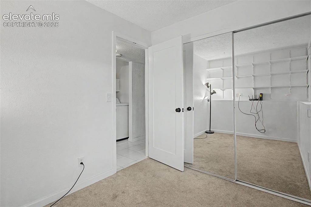 Image 21 of 37: Room featuring wall-to-wall carpeting, white painted walls, and a white int