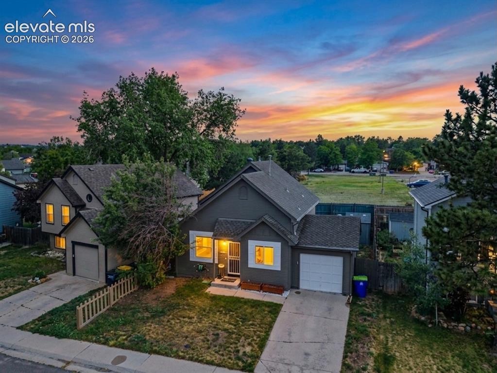 Image 3 of 37: Single-family residence featuring a two-car garage, front yard with mature