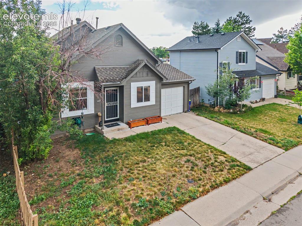 Image 33 of 37: Single-family residence featuring a prominent front-facing garage, a concre