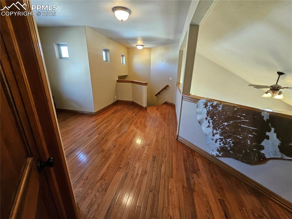 Image 18 of 48: Spacious upstairs landing with hardwood / wood-style flooring
