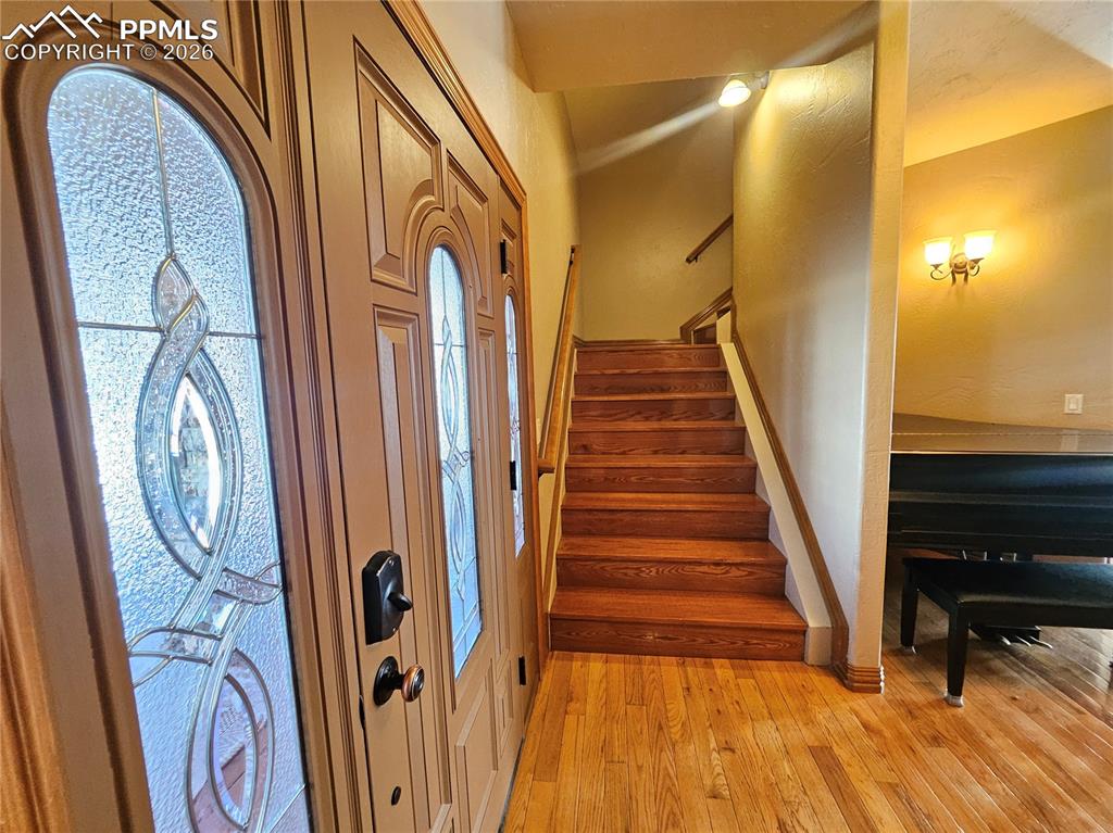 Image 2 of 48: Foyer entrance featuring stairs and light wood-style floors