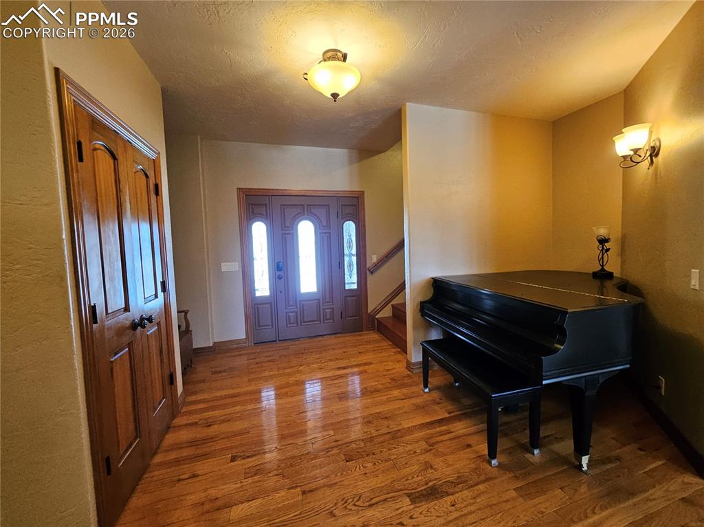 Image 3 of 48: Foyer with wood finished floors