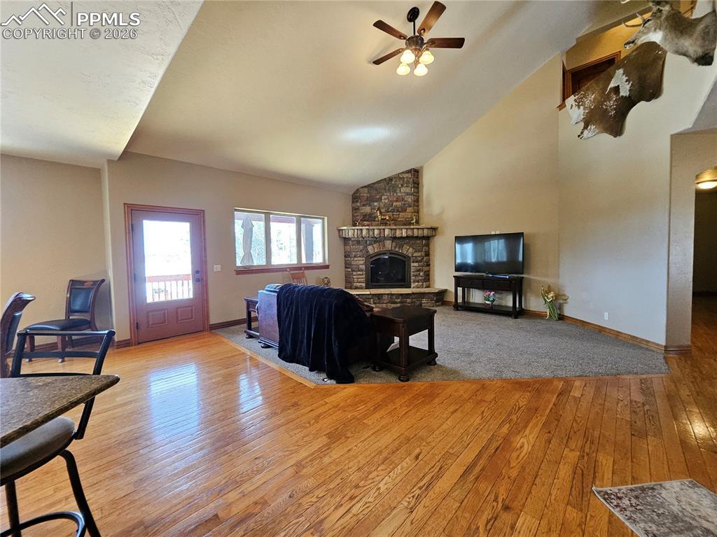 Image 5 of 48: Living room featuring ceiling fan, light wood-style flooring, vaulted ceili