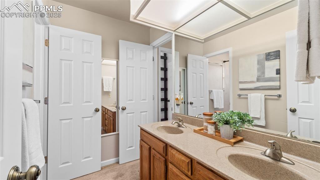 Image 18 of 38: Upstairs bathroom has dual vanity