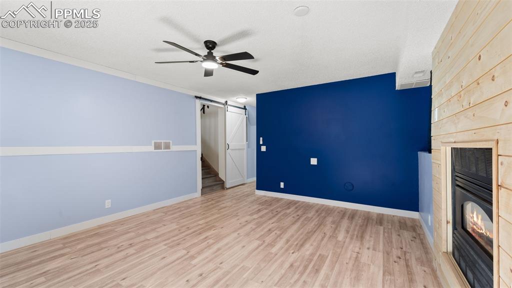 Image 22 of 38: Lower level rec room has gas fireplace.