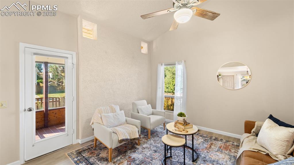 Image 5 of 38: Living room with adjacent sunroom.