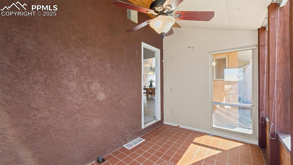 Image 7 of 38: Sunroom entry is right next to the front door.
