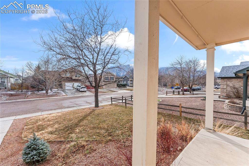 Image 27 of 28: Inviting front porch with amazing view of Cheyenne Mountain