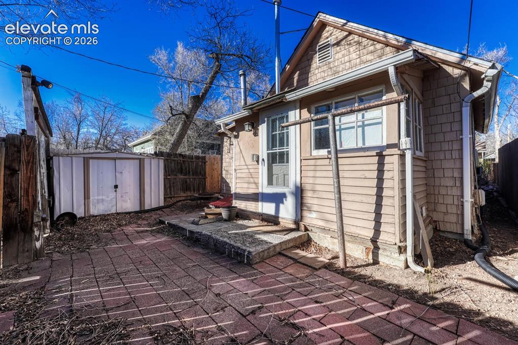Image 35 of 42: Fenced back yard includes shed