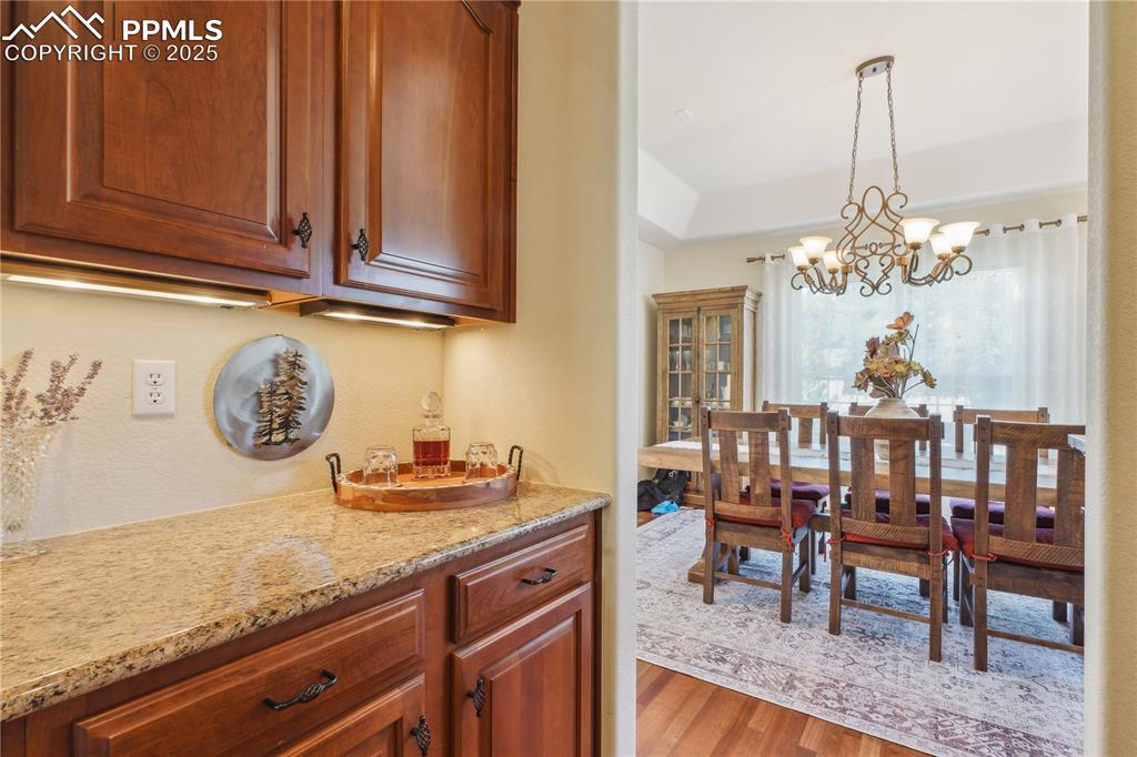 Image 12 of 41: Dining area with a notable chandelier and wood finished floors