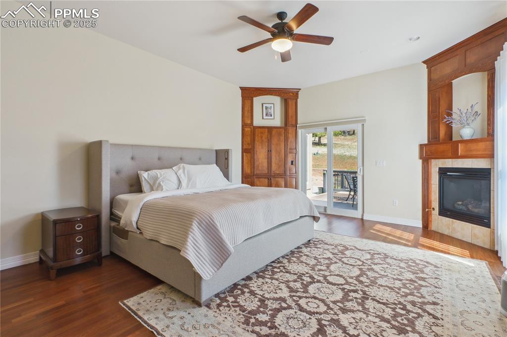Image 14 of 41: Bedroom featuring baseboards, dark wood-style flooring, ceiling fan, access