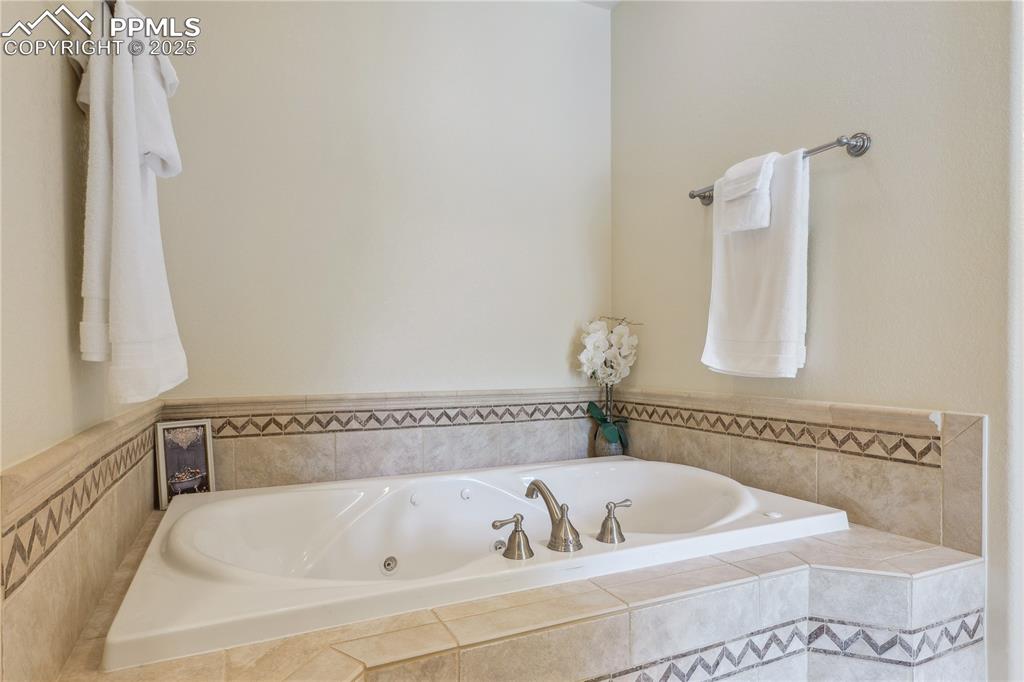 Image 15 of 41: Full bathroom featuring a whirlpool tub