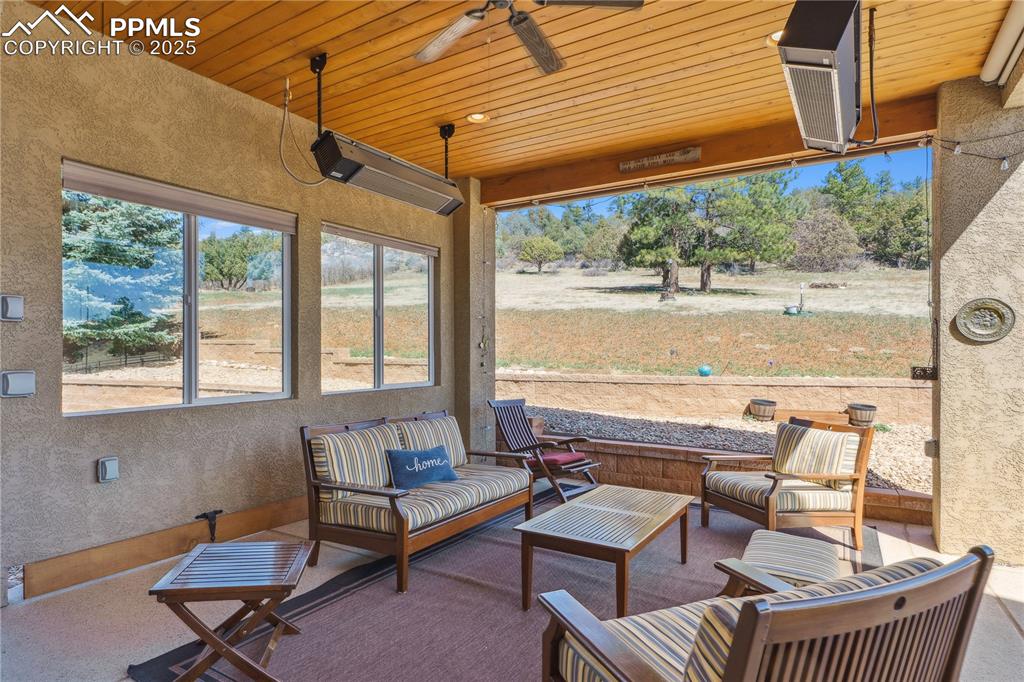 Image 33 of 41: Sunroom with an outdoor hangout area and a ceiling fan