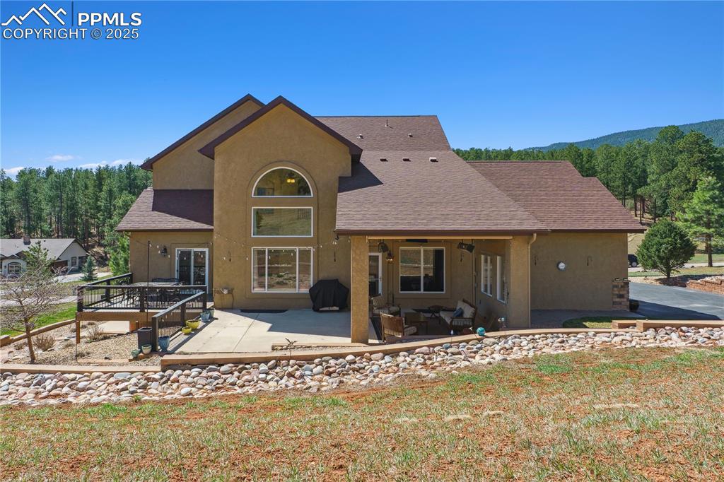 Image 35 of 41: Back of house with a patio area, stucco siding, and a shingled roof