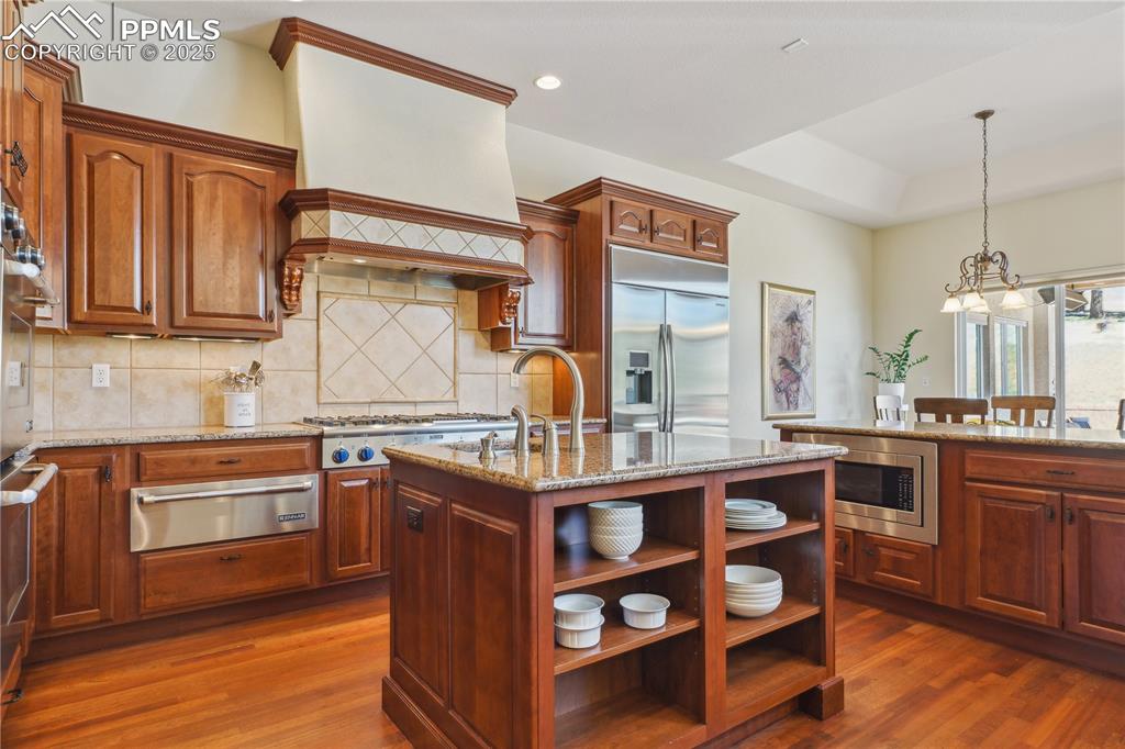 Image 6 of 41: Kitchen featuring built in appliances, a warming drawer, open shelves, and