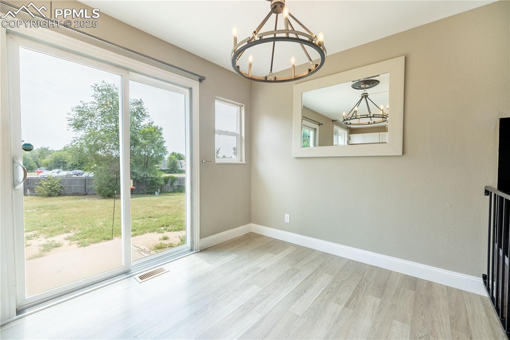 Image 11 of 28: Dining Room area with sliding glass doors that open to backyard