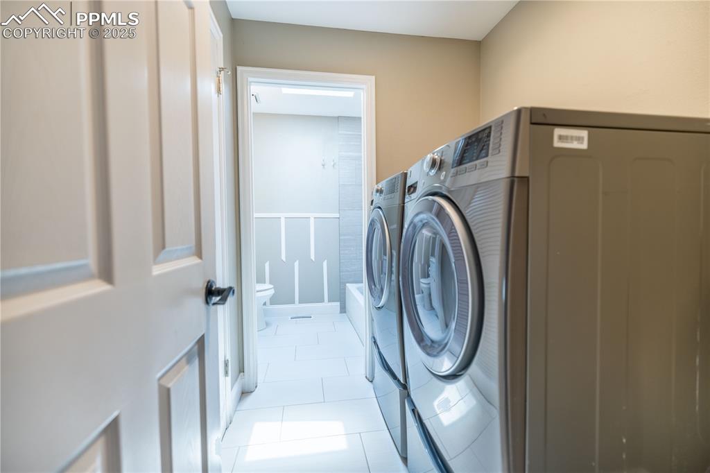 Image 19 of 28: Upstairs Laundry area featuring washer and dryer