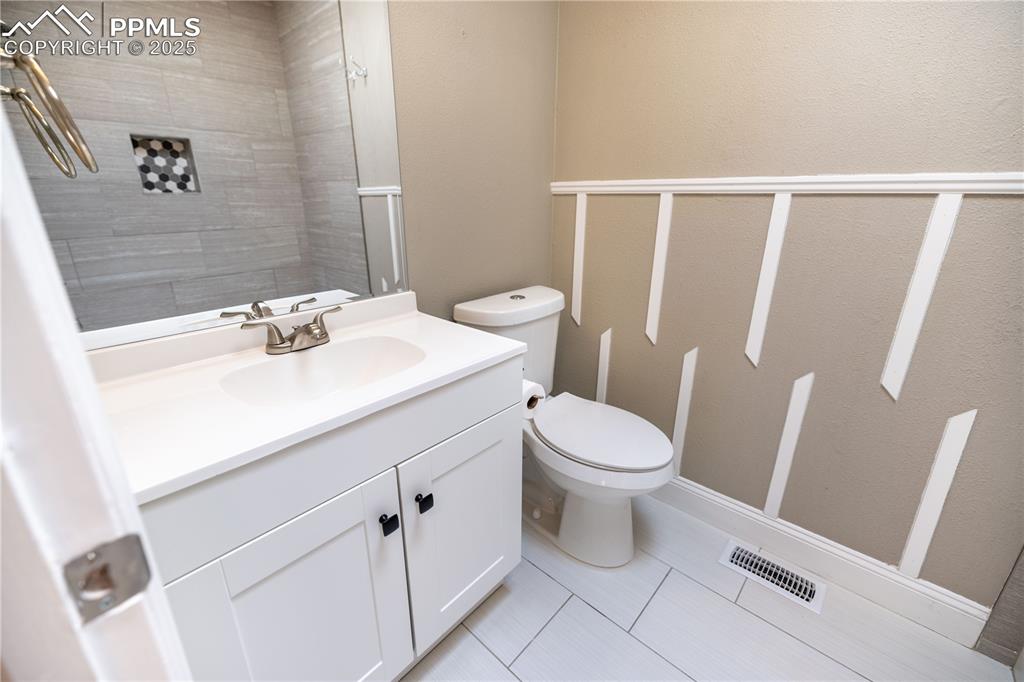 Image 20 of 28: Upstairs Full bath with vanity and tile patterned floors