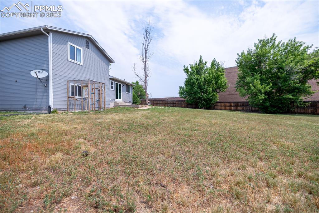 Image 28 of 28: View of yard with entry steps