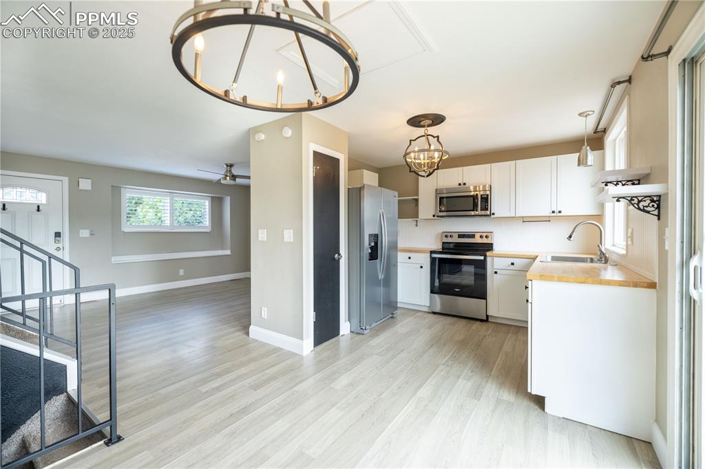 Image 7 of 28: Open Main level living area with kitchen, dining room, and living room