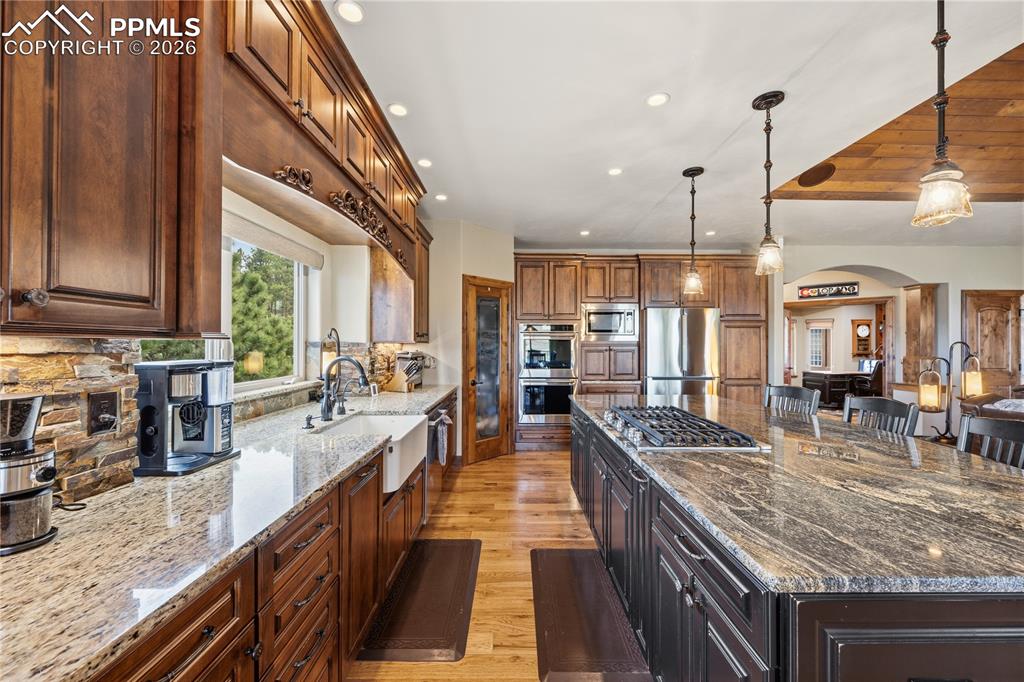 Image 10 of 45: View from eating nook toward foyer. Spacious high grade counter tops, buil