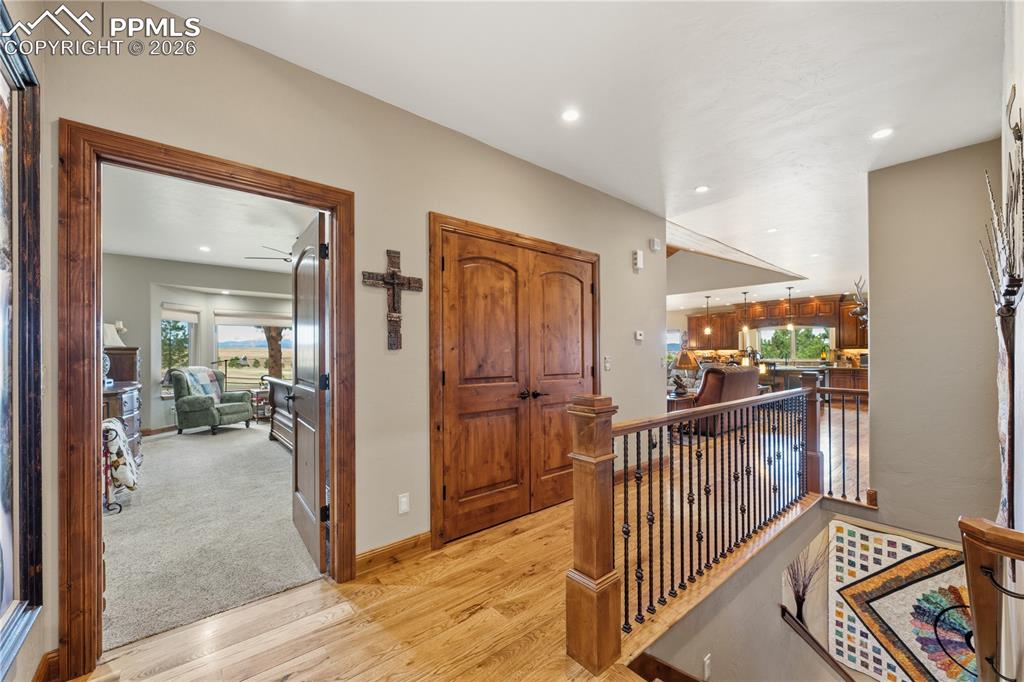 Image 14 of 45: Primary bedroom entry off hallway from garage entry