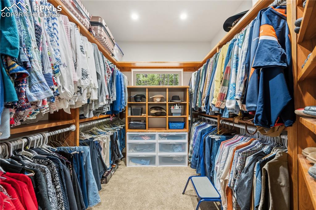 Image 18 of 45: Custom wood shelving with lots of hanging space to maintain a well organize
