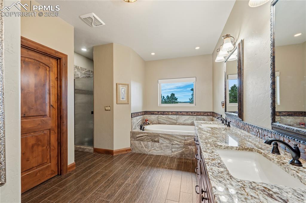 Image 19 of 45: Showing double vanities, tub, and entrance to spacious walk in shower