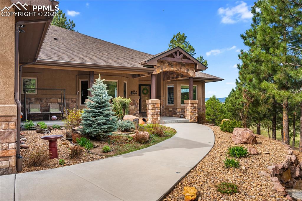 Image 2 of 45: Established landscaping leading to covered front porch