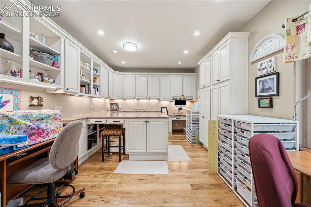 Image 21 of 45: 2nd bedroom on mail level currently being used as an art/sewing room