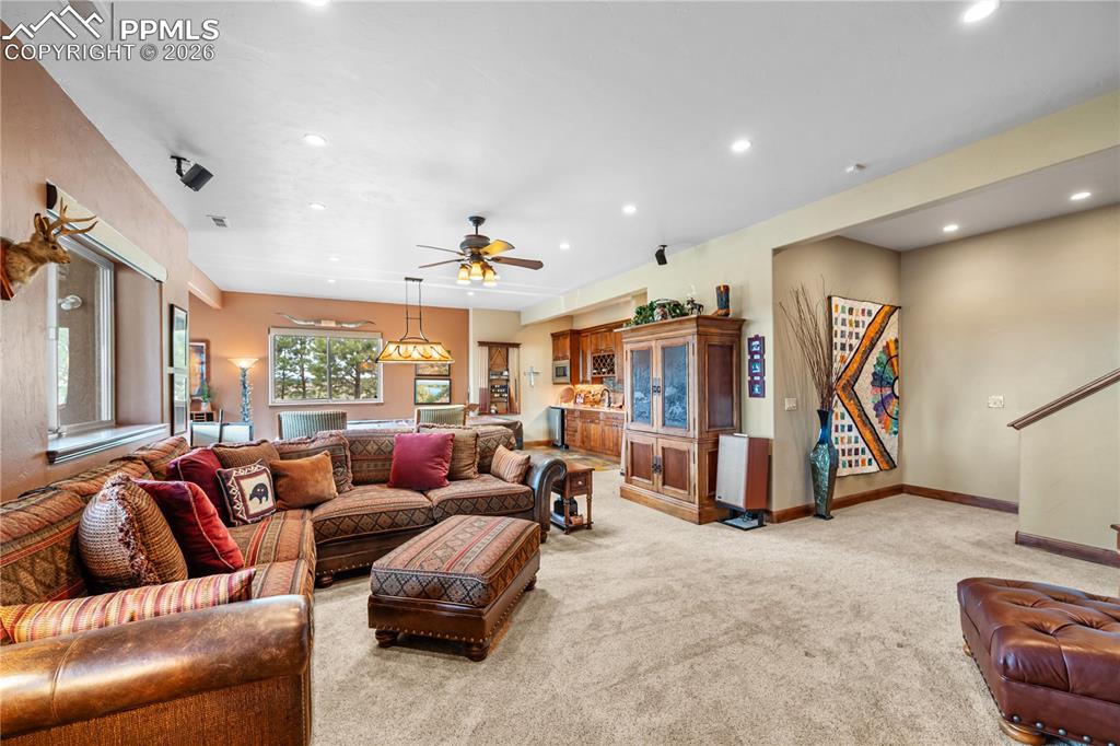 Image 23 of 45: View from wood burning stove to game area and wet bar