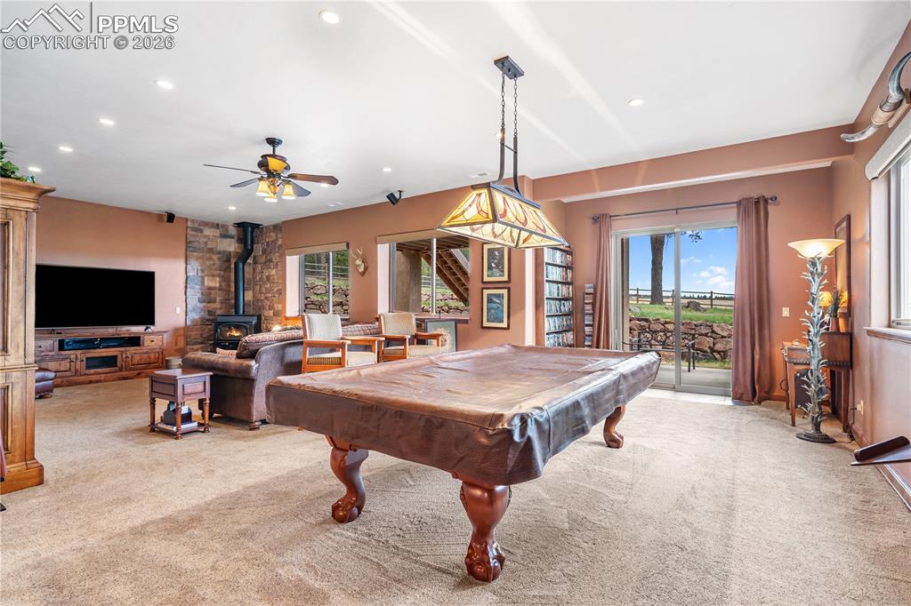 Image 25 of 45: Walkout basement with open family room, pool/game area from wet bar