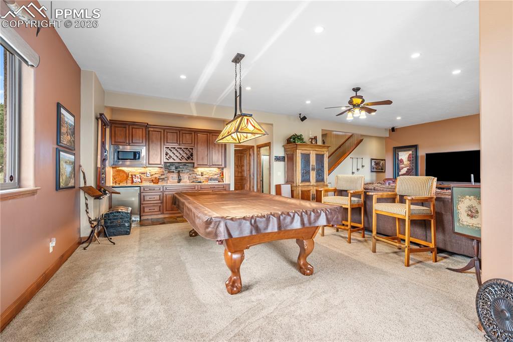 Image 26 of 45: From walkout toward wet bar and family room