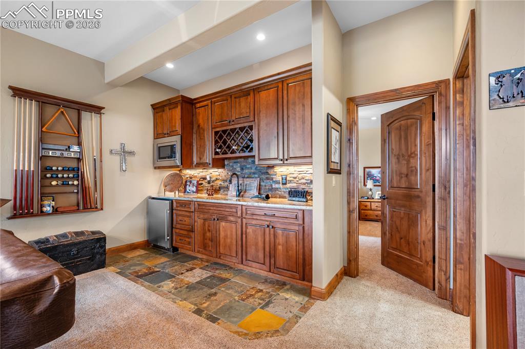 Image 27 of 45: Wet bar and entry to bedroom