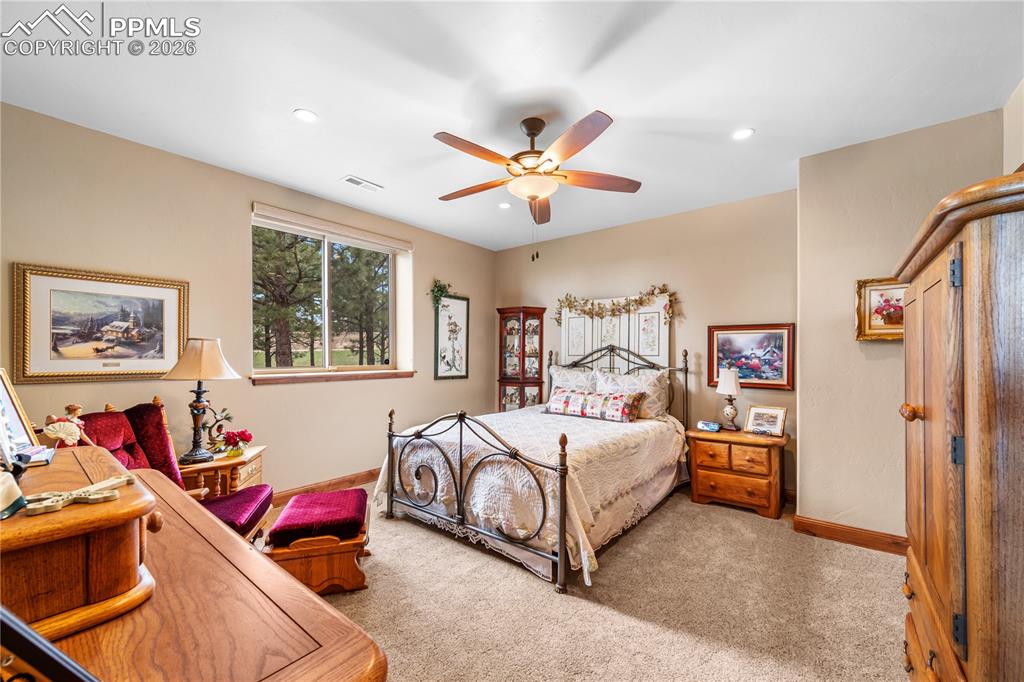 Image 28 of 45: Basement bedroom behind wet bar game room