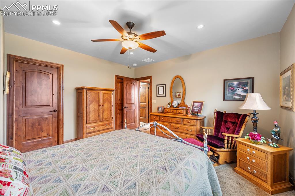 Image 29 of 45: Another view of basement bedroom toward hall bath and wet bar