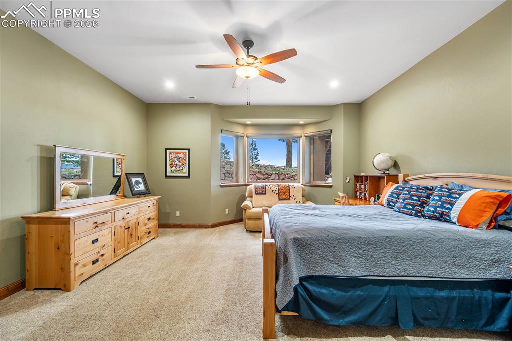 Image 32 of 45: Basement en-suite bedroom with bay windows