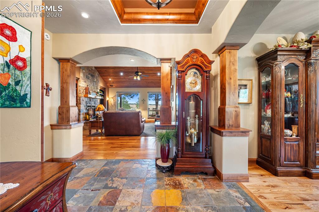 Image 4 of 45: Stone tiled entry transitioning to hickory hardwood flooring o mail level.