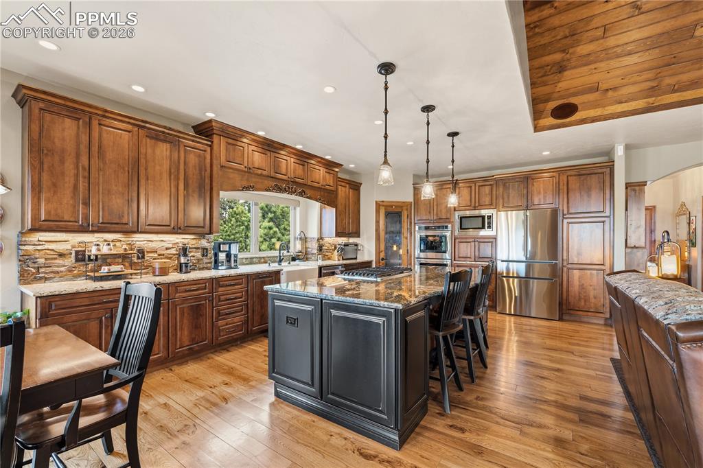 Image 9 of 45: Custom hickory cabinets, high grade granite counter, built in SS appliances