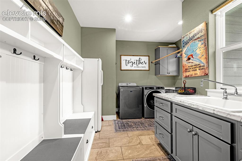 Image 33 of 49: Wet bar with refrigerator and microwave in basement adjacent to theater roo