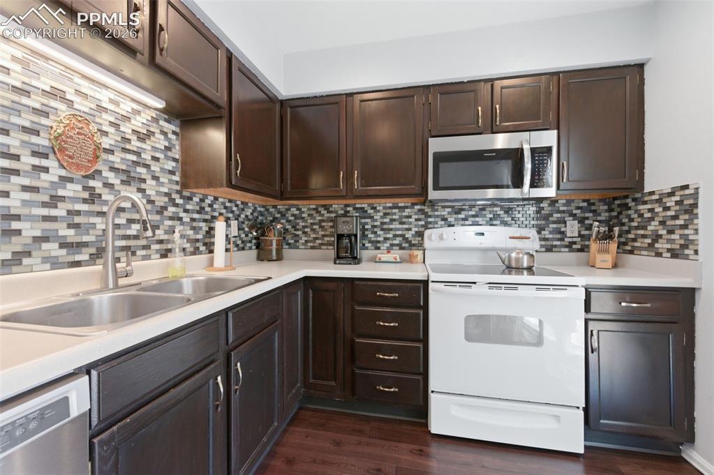 Image 11 of 26: Updated cabinets, flooring, appliances and backsplash