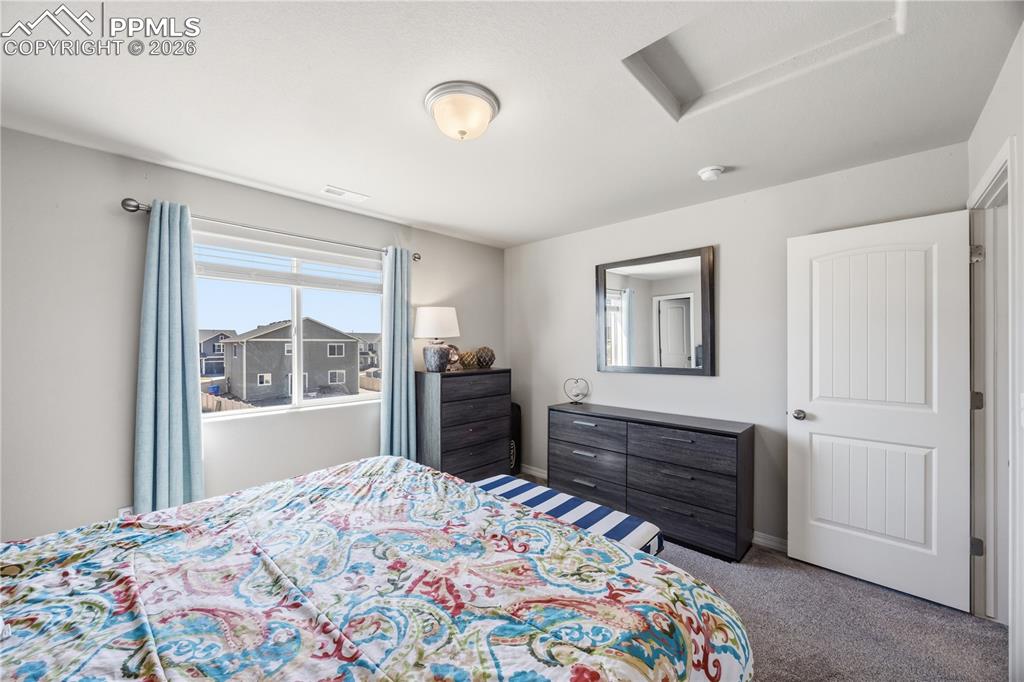 Image 20 of 41: Upper Level Bedroom #1 with neutral carpet.