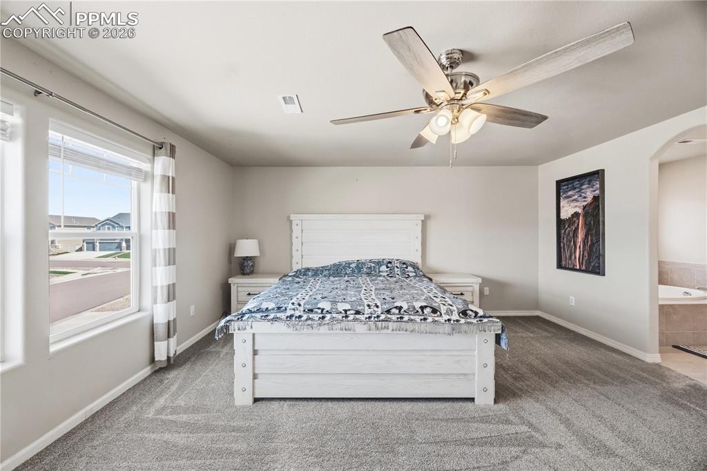 Image 25 of 41: Upper Level Full Hall Bathroom with vanity, mirror, and tiled tub/shower.