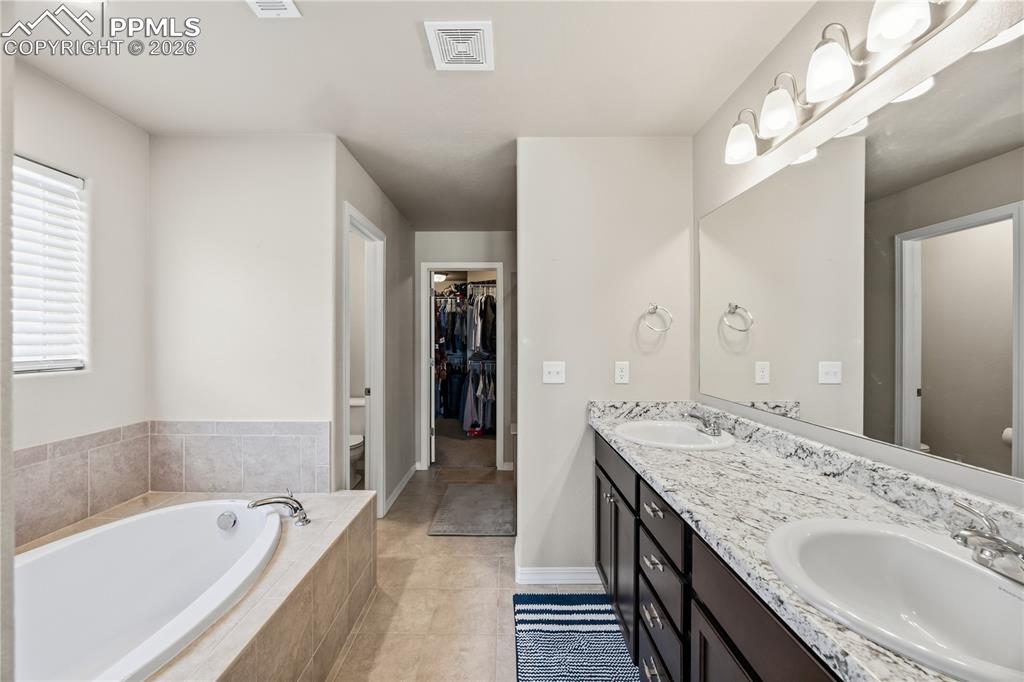 Image 28 of 41: Upper Level Primary Bedroom with archway into the 5pc Primary Bathroom.