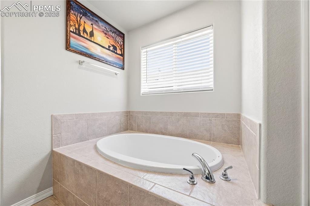Image 32 of 41: Separate shower and walk in closet in the Primary Bathroom.