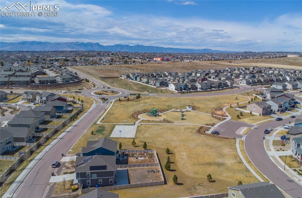 Image 37 of 41: Large fenced backyard with storage shed for tools and toys.